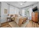 Bright bedroom with a comfortable bed, soft textures, and natural light from the windows at 5101 N Suwanee Ave, Tampa, FL 33603