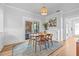 Sunlit dining area featuring a wooden table, seating for four, and seamless access to the outdoor patio at 5101 N Suwanee Ave, Tampa, FL 33603
