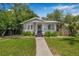 Attractive home boasts a lush front yard, inviting walkway, and traditional design, perfect for families at 5101 N Suwanee Ave, Tampa, FL 33603