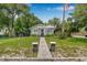 Charming home featuring a well-manicured lawn, walkway, and classic architectural details enhancing curb appeal at 5101 N Suwanee Ave, Tampa, FL 33603