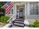 Inviting front entrance featuring a black front door and an American flag at 5101 N Suwanee Ave, Tampa, FL 33603