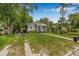 Charming home with a well-manicured lawn, mature trees, and a welcoming front porch, ideal for relaxation at 5101 N Suwanee Ave, Tampa, FL 33603