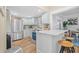 Bright kitchen with stainless steel appliances, a breakfast bar, and updated cabinets at 5101 N Suwanee Ave, Tampa, FL 33603