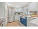Modern kitchen with stainless steel appliances, an island and updated cabinets at 5101 N Suwanee Ave, Tampa, FL 33603