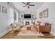 Cozy living room with a fireplace, a ceiling fan and modern furnishings at 5101 N Suwanee Ave, Tampa, FL 33603