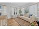Bright living room with a comfortable sofa, large windows, and a cozy rug at 5101 N Suwanee Ave, Tampa, FL 33603