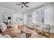 Bright living room with a large window, hardwood floors, and a comfortable seating area at 5101 N Suwanee Ave, Tampa, FL 33603