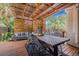 Comfortable patio area features a wooden table and seating, with string lights for ambiance at 5101 N Suwanee Ave, Tampa, FL 33603