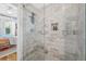 Elegant bathroom shower features marble tiling, a glass door, and built-in shelving at 5101 N Suwanee Ave, Tampa, FL 33603