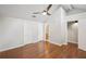 Bedroom featuring wood floors, a ceiling fan, closet doors, and bathroom access, providing convenience and comfort at 5203 Oak Charter Ct # 5203, Temple Terrace, FL 33617