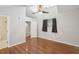 Bright bedroom with hardwood floors, vaulted ceilings, a ceiling fan, and a doorway to the en-suite bathroom at 5203 Oak Charter Ct # 5203, Temple Terrace, FL 33617