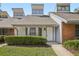 Charming townhome featuring unique architectural details and manicured landscaping at 5203 Oak Charter Ct # 5203, Temple Terrace, FL 33617
