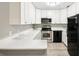 Modern kitchen featuring white cabinets, stainless steel appliances, and light countertops at 5203 Oak Charter Ct # 5203, Temple Terrace, FL 33617