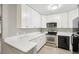 Modern kitchen featuring white cabinets, stainless steel appliances, and light countertops at 5203 Oak Charter Ct # 5203, Temple Terrace, FL 33617