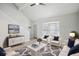 Staged living room featuring new floors, stylish furniture, and a large bay window at 5203 Oak Charter Ct # 5203, Temple Terrace, FL 33617