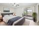 Spacious main bedroom featuring sliding glass doors with access to an outdoor deck at 5203 Oak Charter Ct # 5203, Temple Terrace, FL 33617