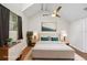 Staged main bedroom with vaulted ceilings, ceiling fan, and bright picture window at 5203 Oak Charter Ct # 5203, Temple Terrace, FL 33617
