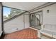 Enclosed patio with tile flooring, comfy seating, and sliding doors for outdoor enjoyment at 5203 Oak Charter Ct # 5203, Temple Terrace, FL 33617