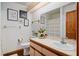 Bright bathroom featuring a framed mirror, decorative art, and vanity with storage at 5301 Bayonne Ave, Spring Hill, FL 34608