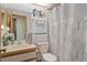 Well-lit bathroom with a decorative mirror and a shower-tub combination with nature themed shower curtain at 5301 Bayonne Ave, Spring Hill, FL 34608
