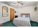 Cozy bedroom featuring a decorative mirror, wood-look closet, and comfortable queen size bed at 5301 Bayonne Ave, Spring Hill, FL 34608