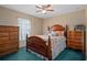 Charming bedroom with wood furniture, ceiling fan, and a comfortable bed dressed in a floral quilt at 5301 Bayonne Ave, Spring Hill, FL 34608