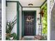 Inviting front door featuring a wreath, lush greenery, decorative accents, and welcome sign at 5301 Bayonne Ave, Spring Hill, FL 34608