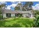 Attractive single Gathering home with green shutters, lush landscaping, and a well maintained lawn at 5301 Bayonne Ave, Spring Hill, FL 34608