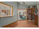 An interior view of the living room is captured through the pass through window from the office space at 5301 Bayonne Ave, Spring Hill, FL 34608