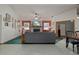 Spacious living room featuring a brick fireplace, large windows, ceiling fan and tile flooring at 5301 Bayonne Ave, Spring Hill, FL 34608
