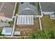 Aerial view of backyard with white fence, patio, gray shed, and green bushes at 547 Summer Sails Dr, Valrico, FL 33594