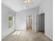 Bright bedroom with vaulted ceiling, carpet, window and en suite bathroom entrance at 547 Summer Sails Dr, Valrico, FL 33594