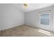 Bedroom featuring neutral carpet, ceiling fan, window, and light gray walls at 547 Summer Sails Dr, Valrico, FL 33594