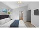 This bedroom features vaulted ceilings, a plush bed, and an ensuite bathroom at 547 Summer Sails Dr, Valrico, FL 33594