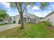 The front exterior of the home with a lovely lawn and mature tree at 547 Summer Sails Dr, Valrico, FL 33594