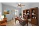 Functional home office featuring a desk, bookcase, chair, and natural light at 547 Summer Sails Dr, Valrico, FL 33594