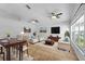 Bright living room features neutral furniture, ceiling fans, tile flooring and large windows for ample natural light at 547 Summer Sails Dr, Valrico, FL 33594