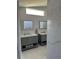 Updated bathroom featuring double vanities, marble floors, and walk-in shower for a luxurious feel at 5494 Sabal Trace Dr, North Port, FL 34287