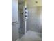 Spa-like shower with marble tiling and modern fixtures, plus convenient towel storage at 5494 Sabal Trace Dr, North Port, FL 34287