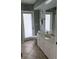 Bathroom features a door to the outside, white cabinets and a sink at 5494 Sabal Trace Dr, North Port, FL 34287