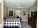 Well-lit bedroom showcases natural light, decorative artwork, and a desk for working or study at 5494 Sabal Trace Dr, North Port, FL 34287