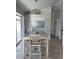 Light-filled dining area with wooden table and chairs, adjacent to large windows at 5494 Sabal Trace Dr, North Port, FL 34287