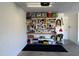 Garage featuring pegboard and shelving for storage and organization at 5494 Sabal Trace Dr, North Port, FL 34287