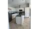 Well-equipped kitchen features stainless steel appliances, ample counter space, and white cabinetry at 5494 Sabal Trace Dr, North Port, FL 34287