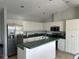 Well-equipped kitchen features modern stainless steel appliances, ample counter space, and white cabinetry at 5494 Sabal Trace Dr, North Port, FL 34287