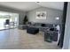 Spacious living room with modern gray furniture and tile floors, perfect for relaxing or entertaining guests at 5494 Sabal Trace Dr, North Port, FL 34287