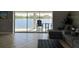 Living room with peaceful views of the lake, couch, and black ottoman at 5494 Sabal Trace Dr, North Port, FL 34287