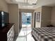Comfortable main bedroom featuring sliding glass doors that lead to a private outdoor pool at 5494 Sabal Trace Dr, North Port, FL 34287