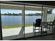 Outdoor patio with seating overlooking a serene lake at 5494 Sabal Trace Dr, North Port, FL 34287
