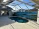 Backyard pool area with decorative mural on the privacy wall at 5494 Sabal Trace Dr, North Port, FL 34287